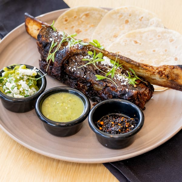El Barrio's grilled short rib with tortillas, guacamole, salsa verde, and chili oil.